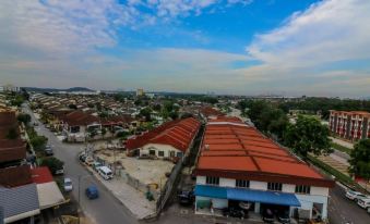 a bird 's eye view of a town with buildings and cars on the street below at Bzz Hotel Skudai