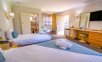a hotel room with two beds , one on the left and one on the right side of the room at Hospitality Esperance, SureStay Collection by Best Western
