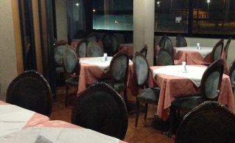 a dining room with tables and chairs arranged for a group of people to enjoy a meal together at Hotel Miramar