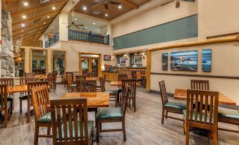 a large dining room with wooden tables and chairs , a bar , and a ceiling fan at Hilton Vacation Club Lake Tahoe Resort South