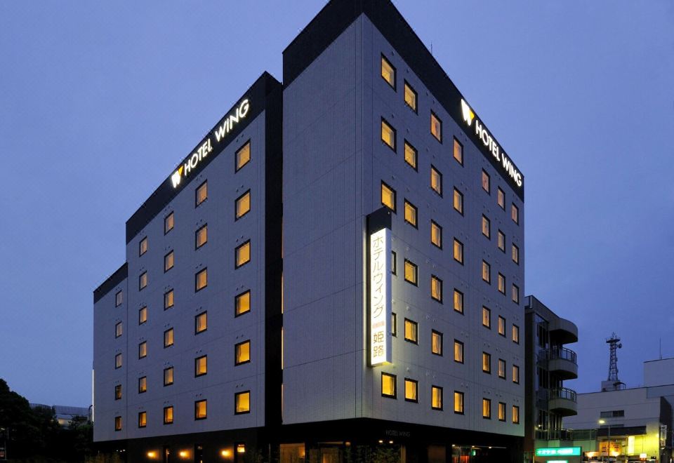 "a modern hotel building with a large glass window and the words "" w hotel "" on top" at Hotel Wing International Himeji