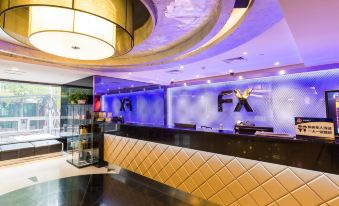 The lobby features a spacious reception desk with a glass front and wood paneling on either side at FX Hotel (Beijing Yansha)