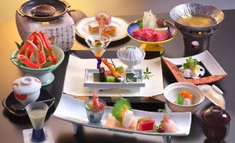 a dining table filled with a variety of food items , including sushi , seafood , and other dishes at Zazan Minakami
