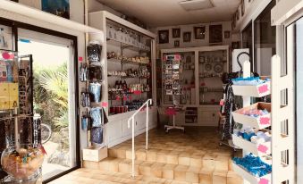 a store with a variety of items for sale , including handbags , shoes , and other accessories at Myosotis