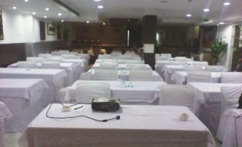 a large conference room filled with rows of chairs and tables , ready for a meeting or event at Amara Hotel