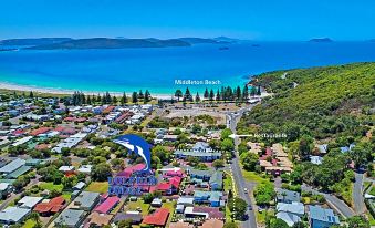 a bird 's eye view of a coastal town with buildings , trees , and the ocean in the background at Dolphin Lodge Albany - Self Contained Apartments at Middleton Beach