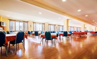 a large , empty banquet hall with multiple dining tables and chairs arranged for a conference or event at La Canada