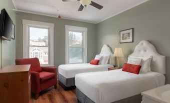 a hotel room with two beds , one on the left and one on the right side of the room at Thayers Inn