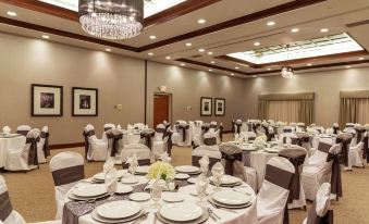 a large banquet hall with multiple tables and chairs set up for a formal event at Hilton Garden Inn Columbus/Edinburgh
