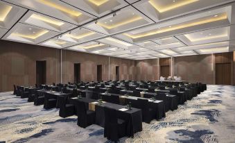 a large conference room with rows of tables and chairs , all set up for a meeting or event at Royal Tulip Golf Resort Gunung Geulis