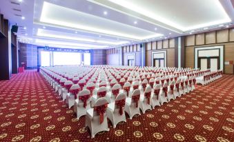 a large conference room with rows of chairs arranged in a symmetrical fashion , ready for an event at Muong Thanh Grand Hoang Mai - Nghe An