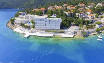 a bird 's eye view of a building surrounded by water and surrounded by trees and buildings at Aminess Lume Hotel