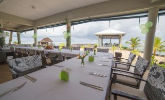 a dining room with several tables and chairs , some of which are set up for a formal event at Saletoga Sands Resort & Spa