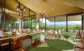 a large dining room with tables and chairs arranged for a group of people to enjoy a meal at Wisterian Life Club Nojiriko
