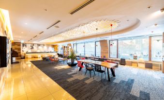 a modern hotel lobby with multiple seating areas , a reception desk , and a large window at Kichijoji Tokyu Rei Hotel