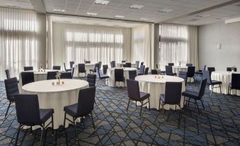 a large conference room with several round tables and chairs arranged for a meeting or event at Courtyard New Carrollton Landover