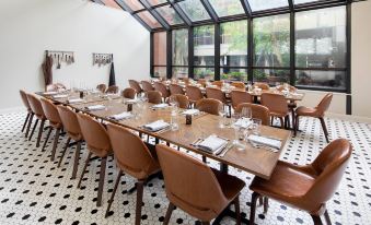 a large dining room with multiple tables and chairs arranged for a group of people to enjoy a meal together at Winston-Salem Marriott