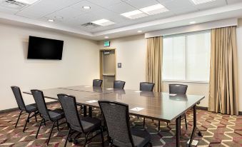 a conference room with a long table and chairs , a television on the wall , and a window at Residence Inn Riverside Moreno Valley