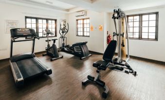 a well - equipped gym with various exercise equipment , including treadmills , weights , and a stationary bike at Kertih Damansara Inn