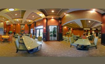 a 3 6 0 - degree panoramic view of a restaurant with multiple dining tables and chairs , as well as a bar area at Homewood Suites by Hilton Bloomington