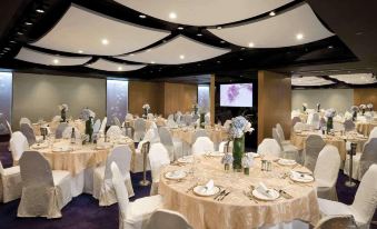 A ballroom at the hotel is arranged with tables and chairs in the center for an event at Novotel Century Hong Kong