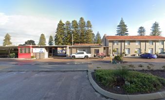 a small town with a car parked in front of a building , surrounded by trees at Hospitality Esperance, SureStay Collection by Best Western