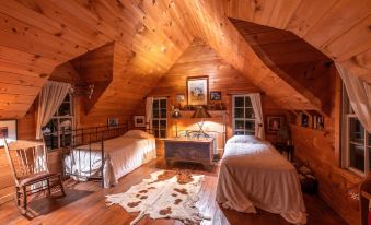 a room with two beds , one on top of the other , in a wooden cabin at Seventy-Four Ranch