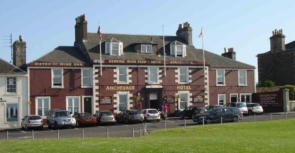 "a large brick building with a sign that reads "" welcome to argyll "" prominently displayed on the front" at The Anchorage Hotel