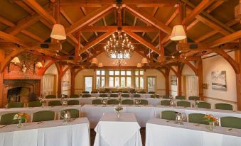 a large dining room with tables and chairs arranged for a formal event , possibly a wedding reception at Trapp Family Lodge