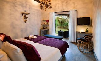 a cozy bedroom with two beds , a window , and a door leading to an outdoor area at Mokuti Etosha