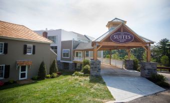 "a hotel entrance with a wooden roof and a sign above it that reads "" suites ""." at Courtyard Philadelphia Springfield