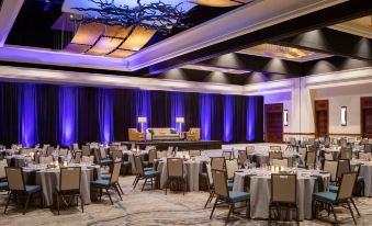 a large banquet hall with multiple tables and chairs set up for a formal event , possibly a wedding reception at JW Marriott San Antonio Hill Country Resort & Spa