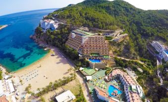 aerial view of a resort on a sandy beach , with multiple buildings and a swimming pool at Ole Galeon Ibiza