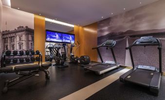 There is a large room with multiple exercise machines, including an indoor treadmill, and a designated area for exercising at Mercure Shanghai Yu Garden On the Bund