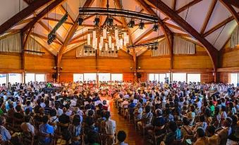 a large crowd of people gathered in a spacious , wooden building , possibly a church or auditorium at Okushiga Kogen Hotel