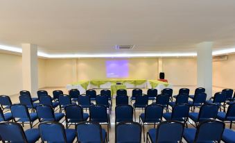 a large conference room with rows of chairs arranged in a semicircle , ready for a meeting at Gran Hotel de Lago - El Coca