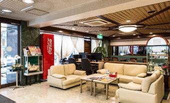 In the center of the lobby, there are couches and tables, as well as an adjacent office space at Hotel Tateshina