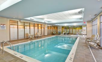 an indoor swimming pool with a water temperature of 1 4 degrees celsius and a ceiling with a skylight at Home2 Suites by Hilton Dickson City Scranton