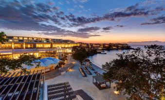 a luxurious resort with a beach , restaurant , and swimming pool at dusk , as well as clear blue skies at Royalton Negril, An Autograph Collection All-Inclusive Resort