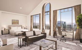 a modern living room with large windows , white furniture , and a view of the city at Signia by Hilton San Jose