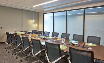 a conference room with a long table and several chairs arranged for a meeting or event at Aloft Seattle Redmond