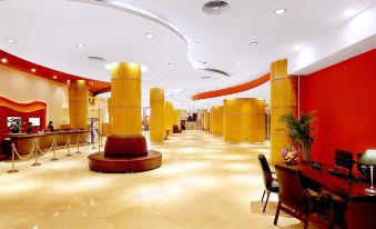 A spacious lobby with a unique ceiling and wall-to-wall carpeting at Beijing Xinqiao Hotel