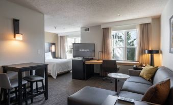 a modern hotel room with a comfortable bed , a flat - screen tv , and a comfortable seating area at Residence Inn by Marriott Princeton at Carnegie Center