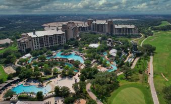 aerial view of a large resort with a water park and a golf course in the background at JW Marriott San Antonio Hill Country Resort & Spa