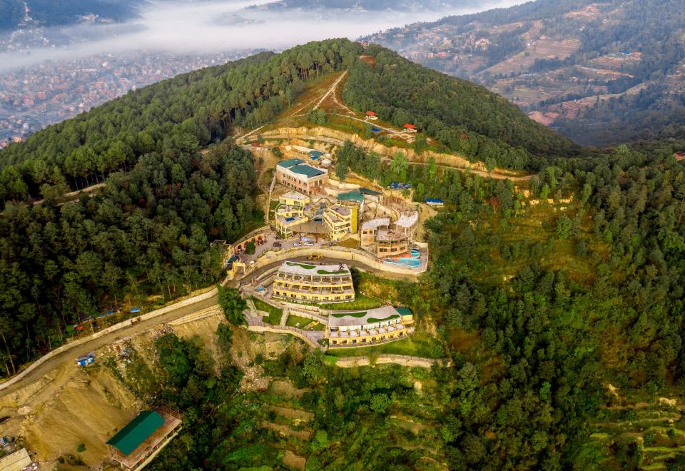 a bird 's eye view of a mountainous area with a hotel and resort complex nestled in the hills at Aagantuk Resort