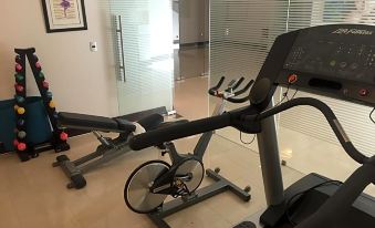 a stationary exercise bike is in a room with glass doors and a framed picture at Casa Torres