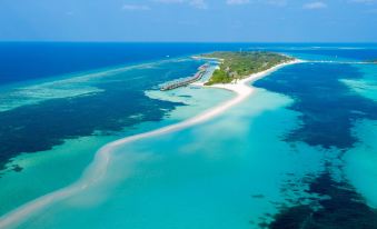 an aerial view of a small island in the ocean , surrounded by clear blue water at Kuredu Island Resort & Spa