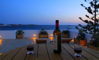 There are two bottles of wine on the table, one of which is red at Brazzera Hotel