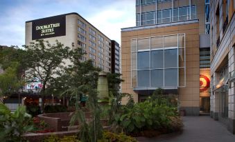 a modern building with a large glass window and a statue in front of it at DoubleTree Suites by Hilton Minneapolis