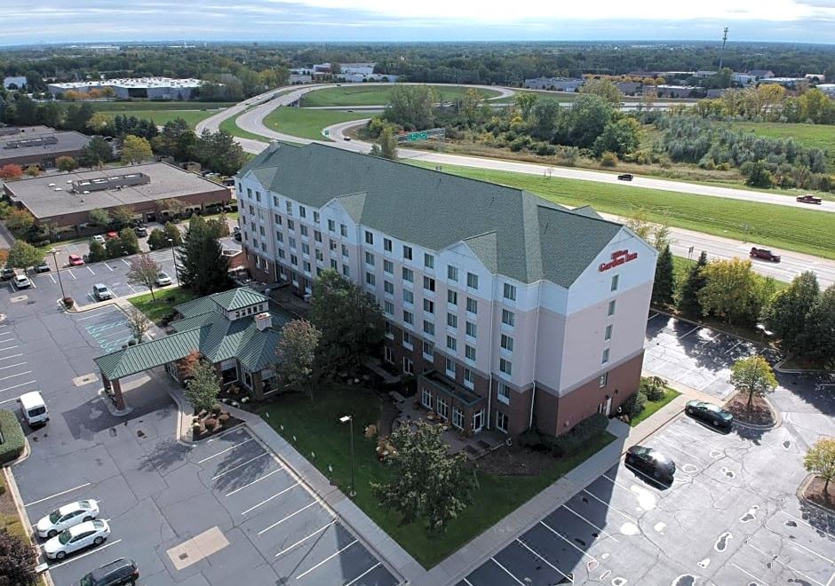 aerial view of a large hotel surrounded by a parking lot , with cars parked in the lot at Hilton Garden Inn Plymouth